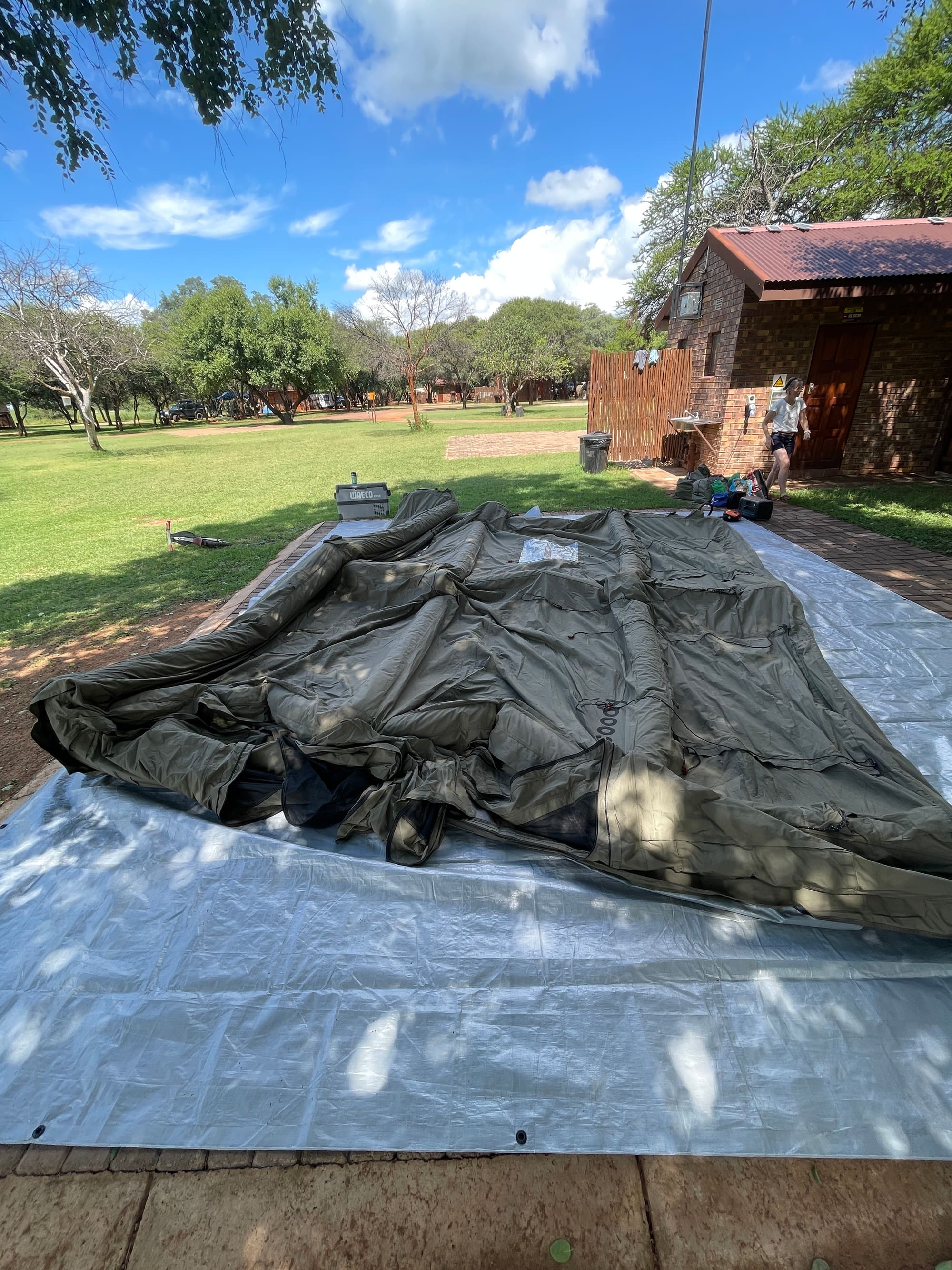 Coody tent bag being rolled out on the grass at Sondela, Bela Bela before setup