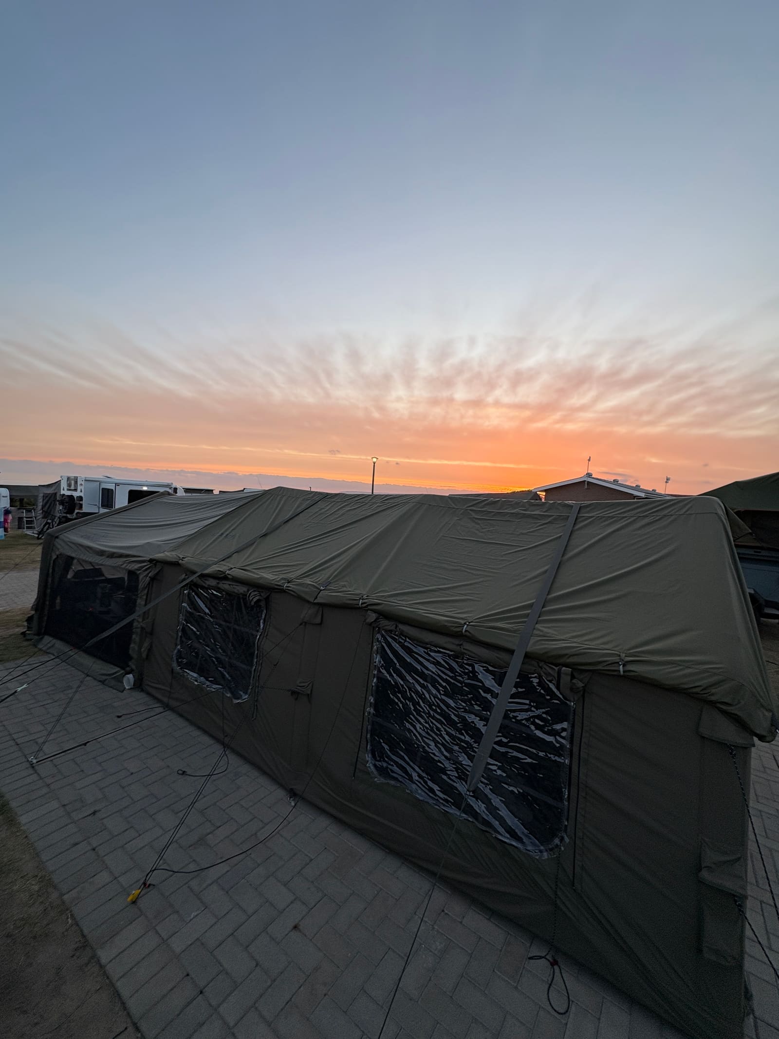 Sunset glow over the ocean beside the Coody Familia tent