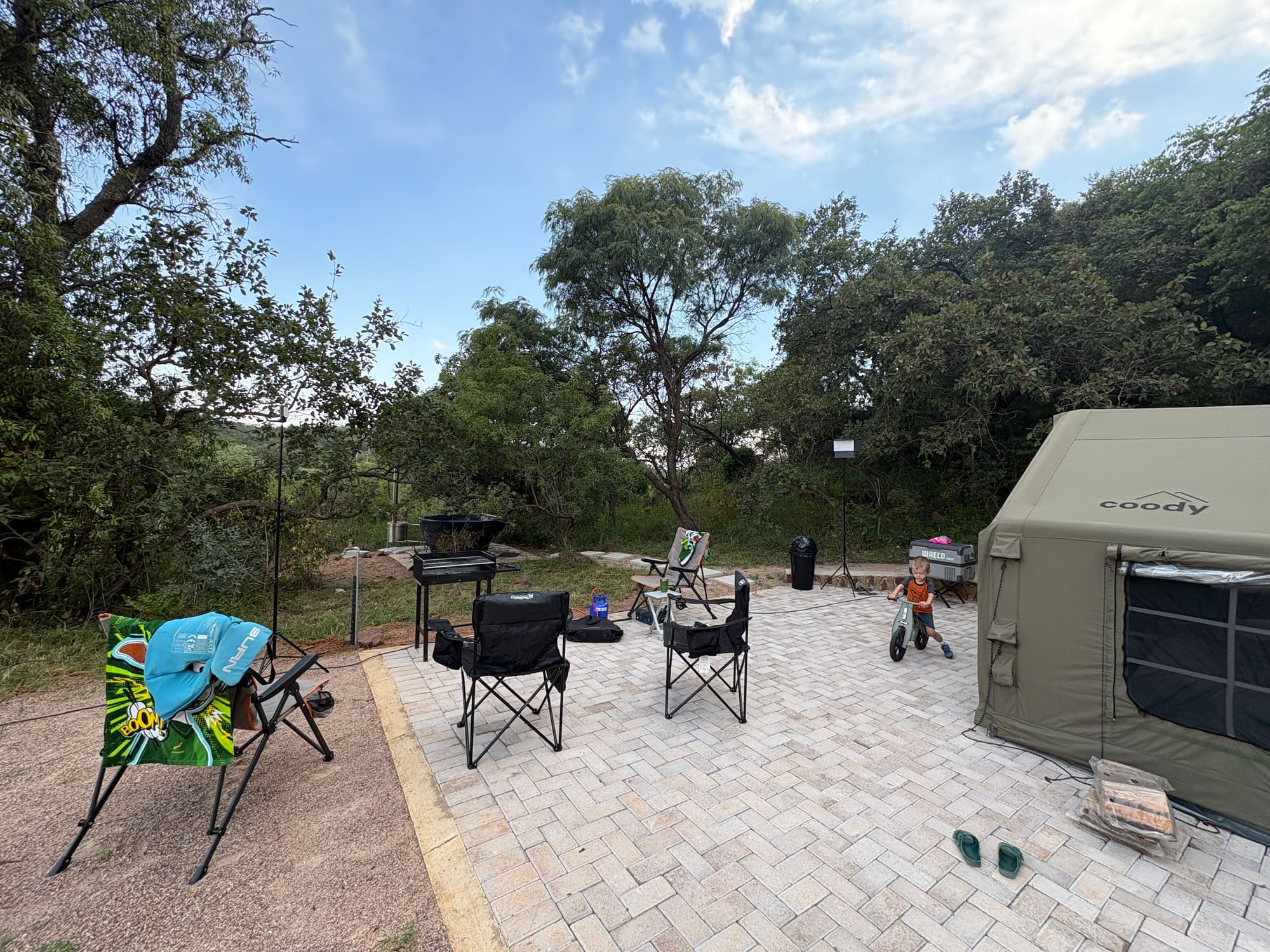 Wide view of the campsite at Kleinood showing the hot tub, braai, and Coody tent together