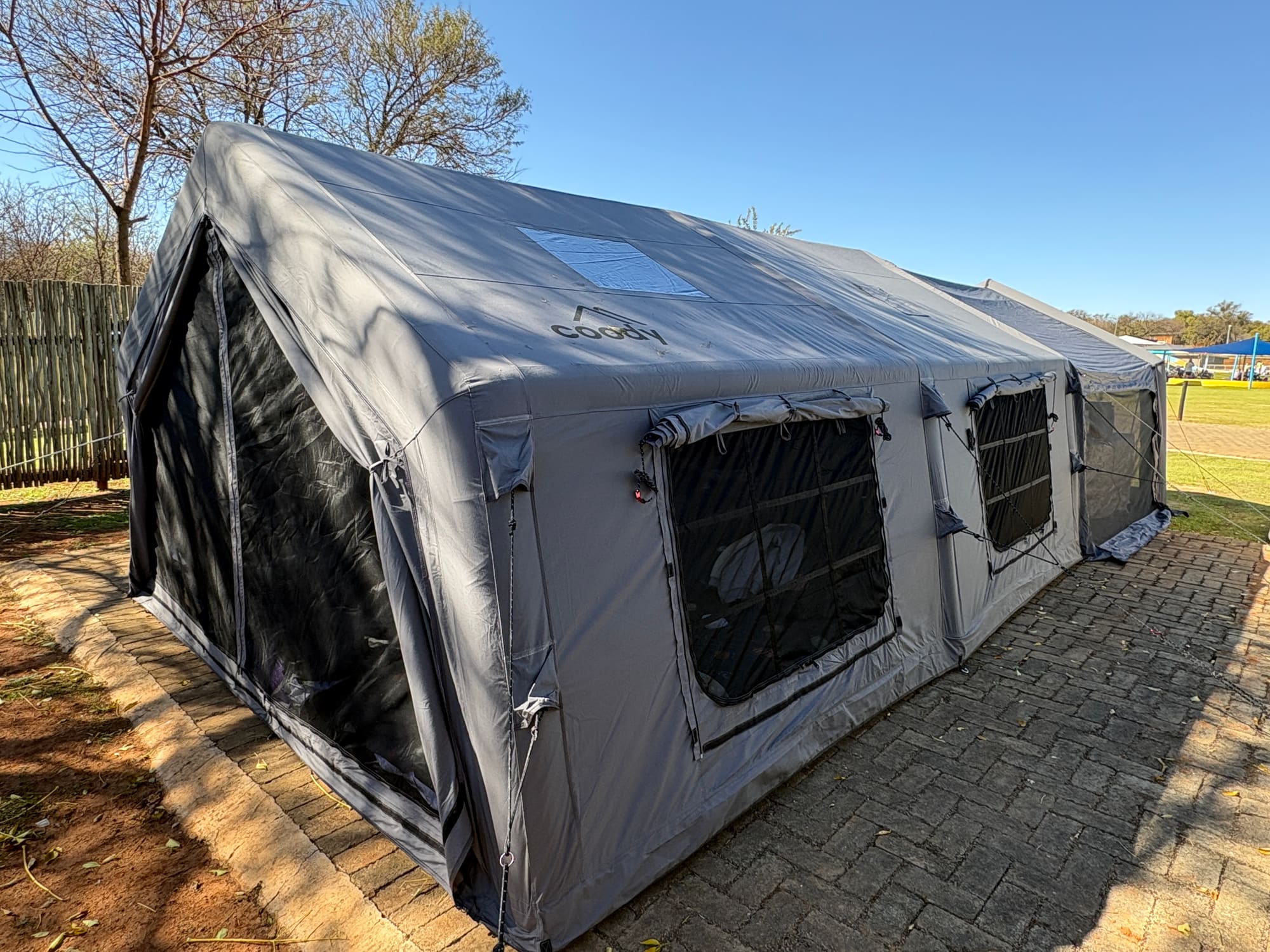 Coody Familia inflatable tent in grey at Konka, Magaliesburg, with mountains in the background