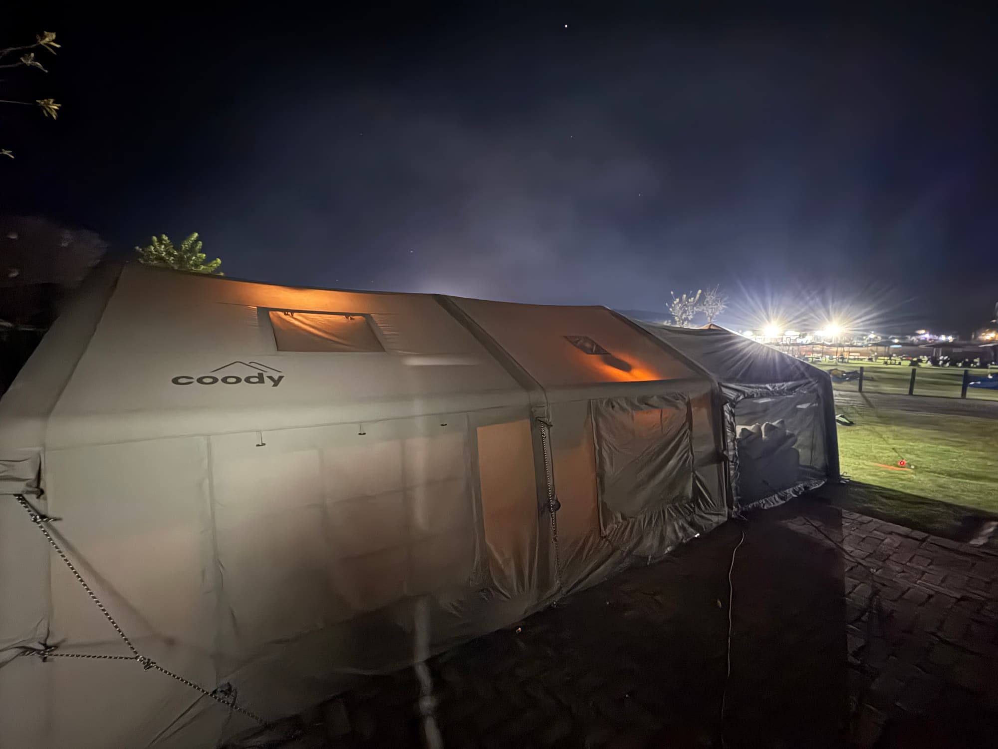 Coody dome tent set up at Konka, Magaliesburg resort during the day, bicycles and cars nearby