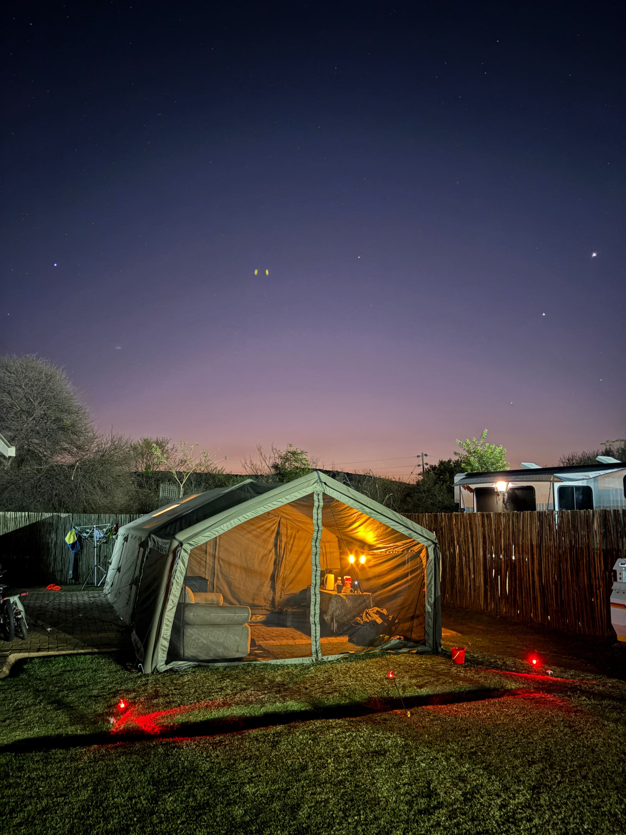Coody dome tent lit up at night at Konka, Magaliesburg, inflatable sofa visible inside