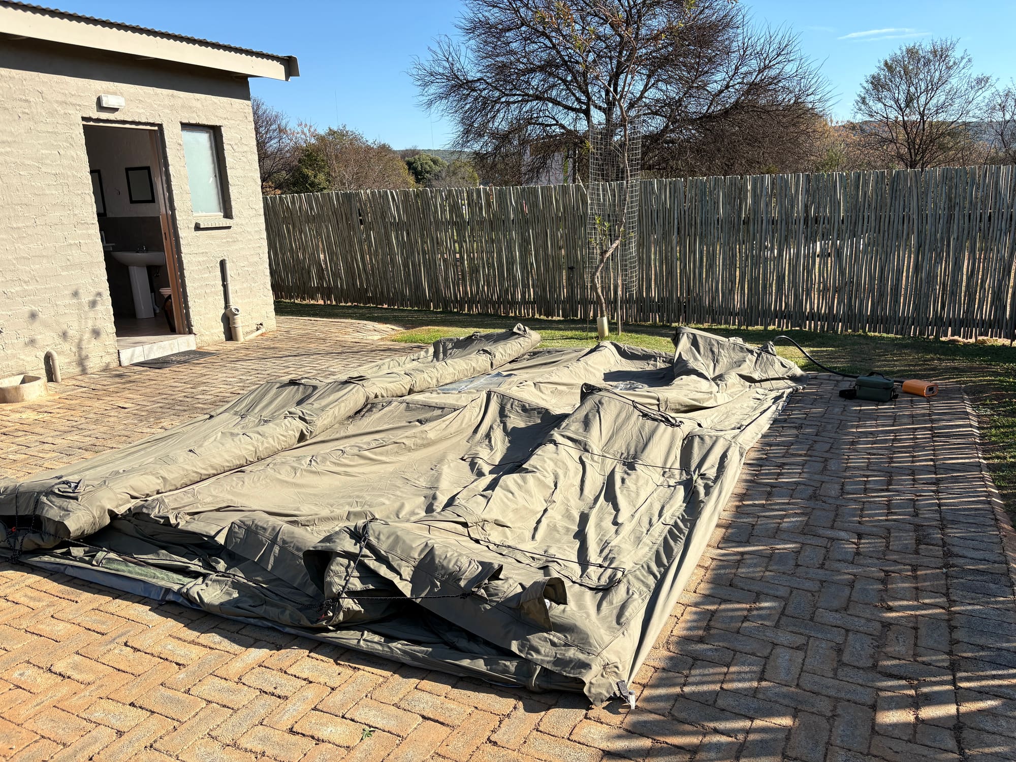 Coody tent canvas rolled out on the patio during setup