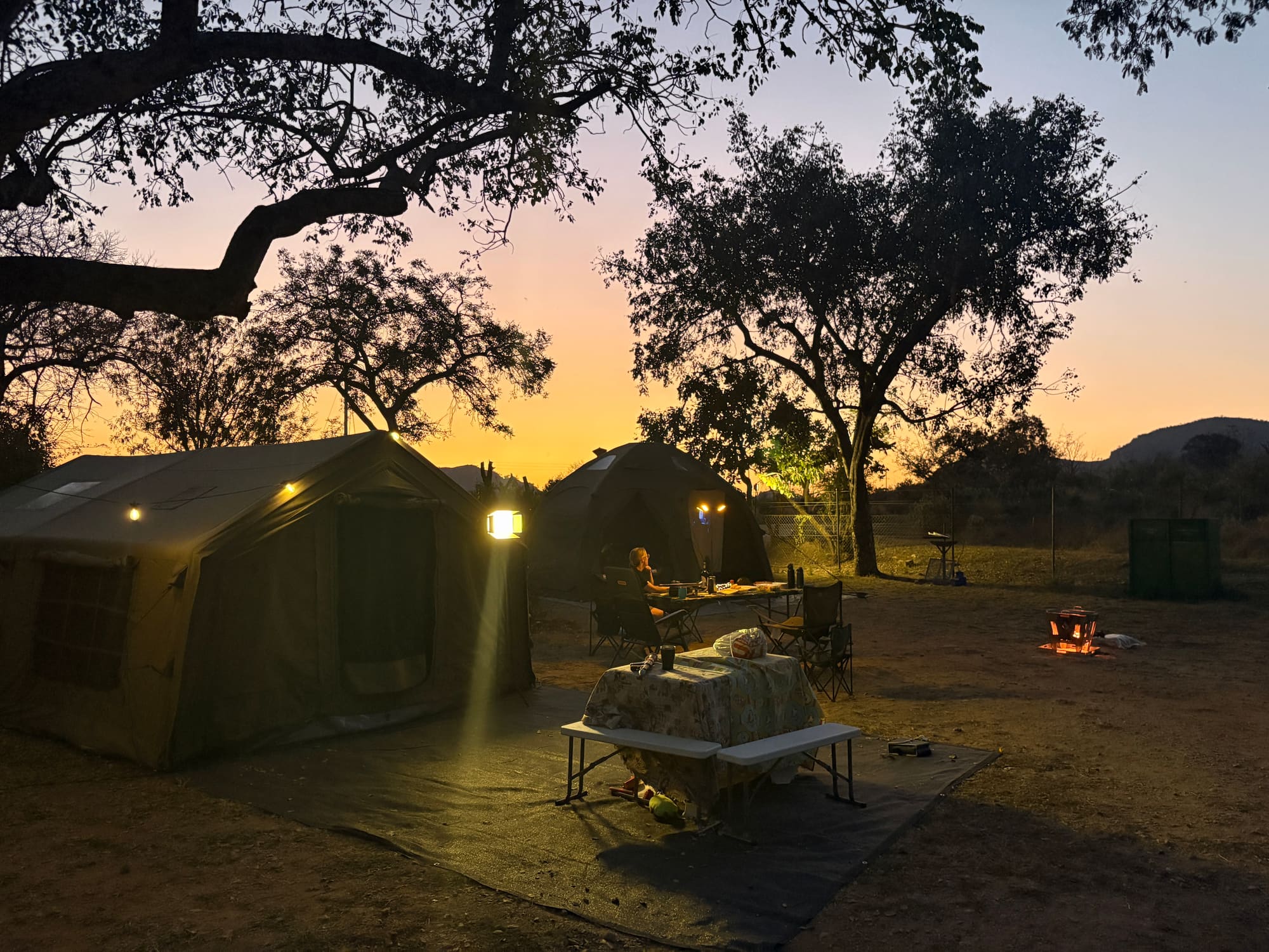 Coody Familia and Coody dome tent lit up at dusk at Malelane, Kruger National Park