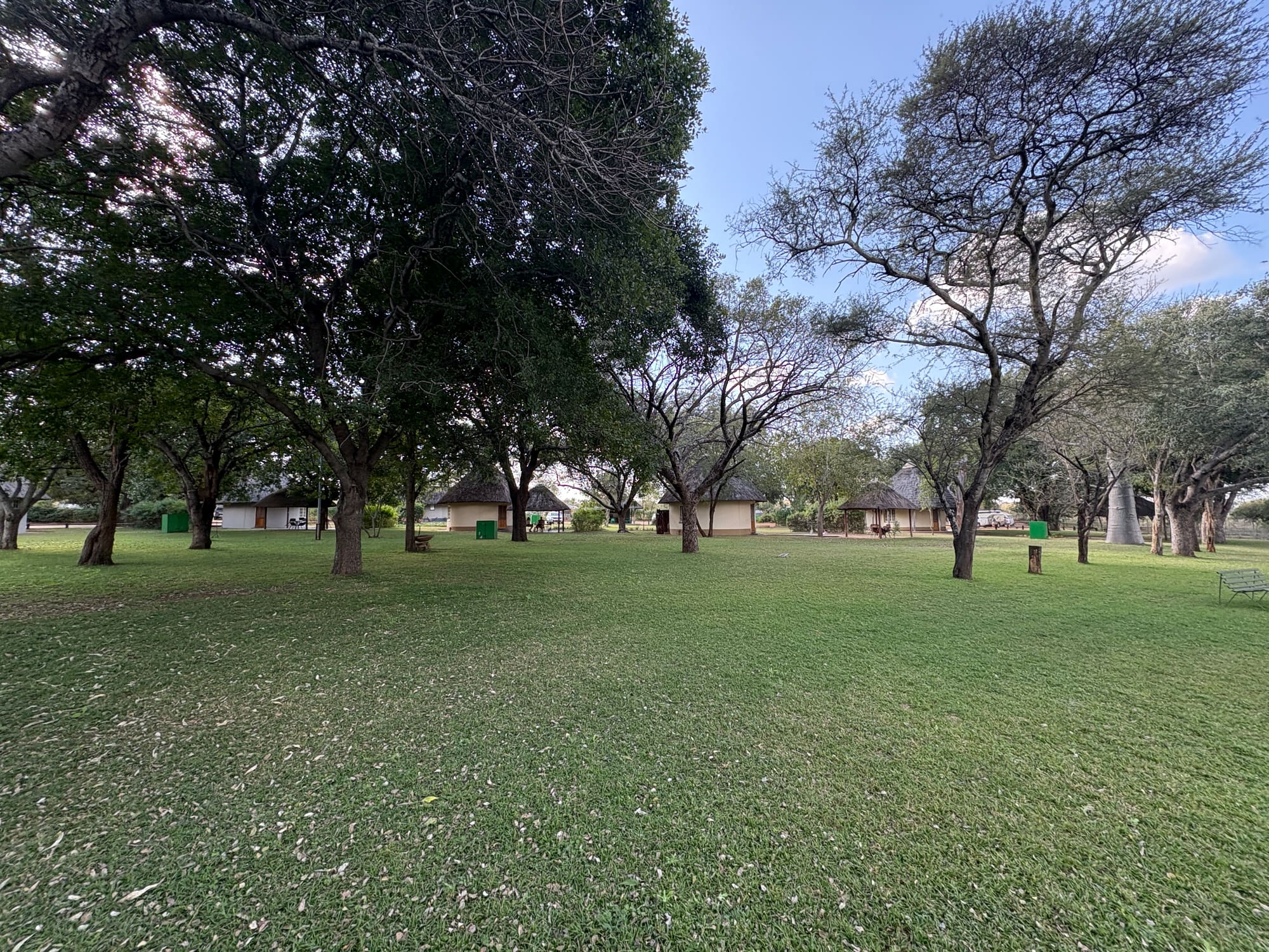 Thatched rondavels and open lawn at Malelane rest camp, Kruger National Park