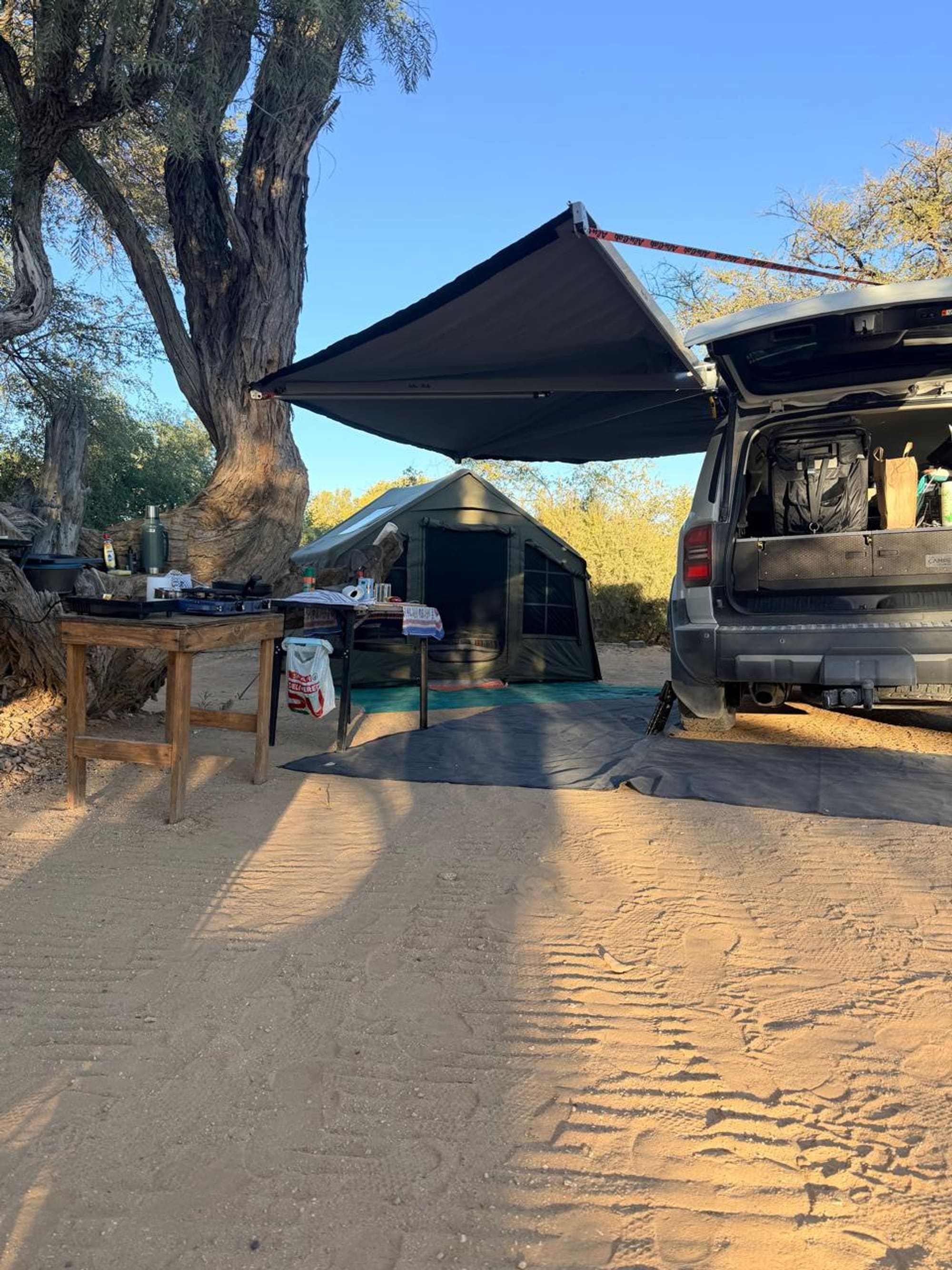 Wider view of the Coody 8 campsite at Spitzkoppe, Namibia, vehicle and awning alongside the tent