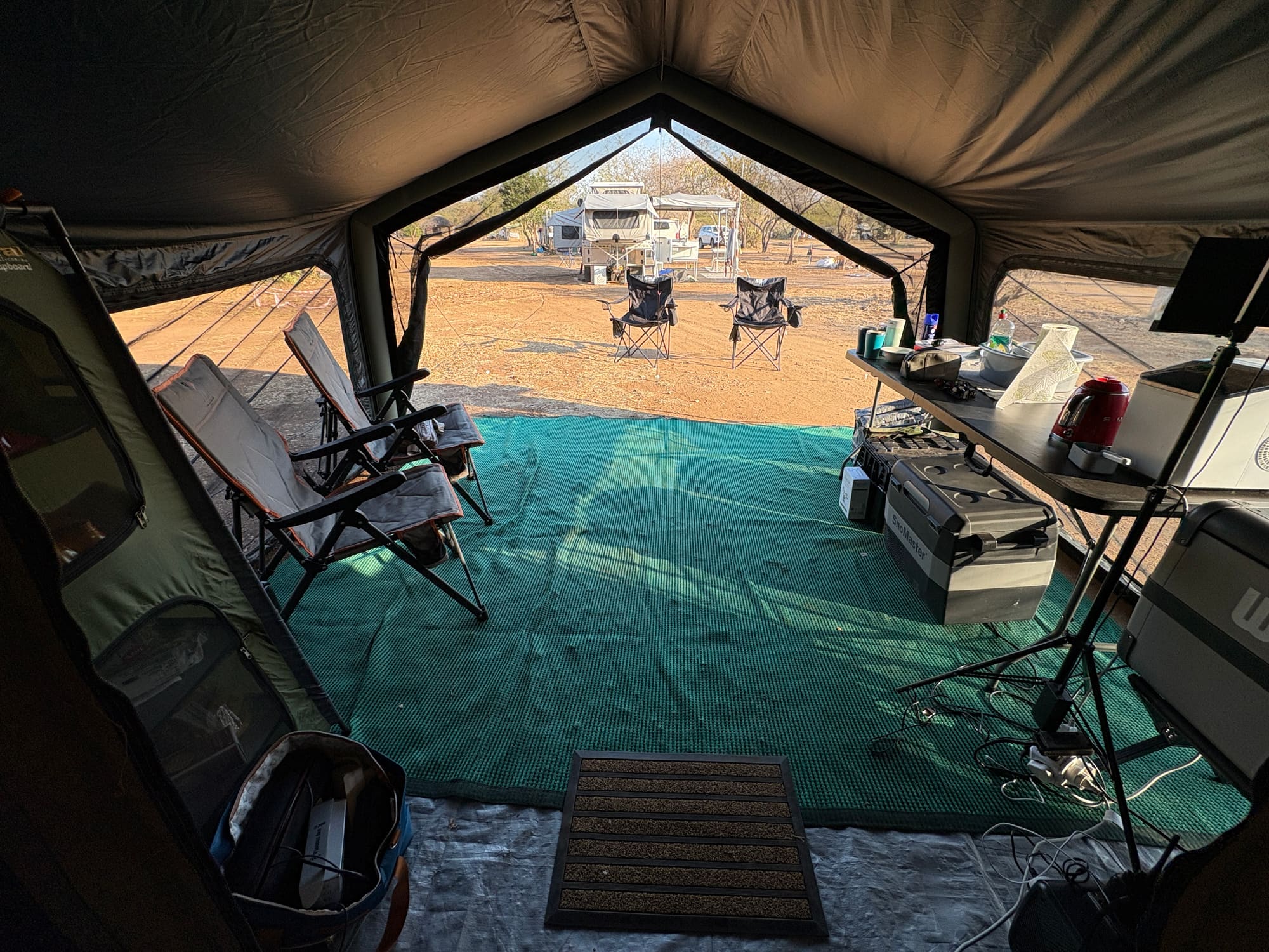 View from inside the Coody Familia annex looking out at camp chairs and the rest of the campsite at Satara