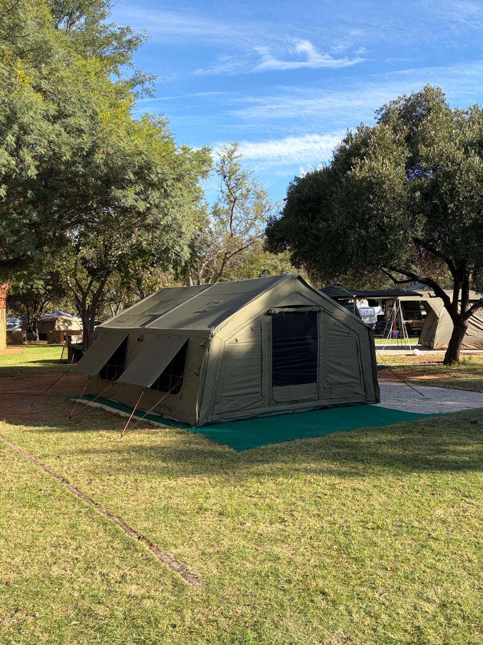 Johan's army green Coody Familia set up on the grass at a campsite in Pretoria