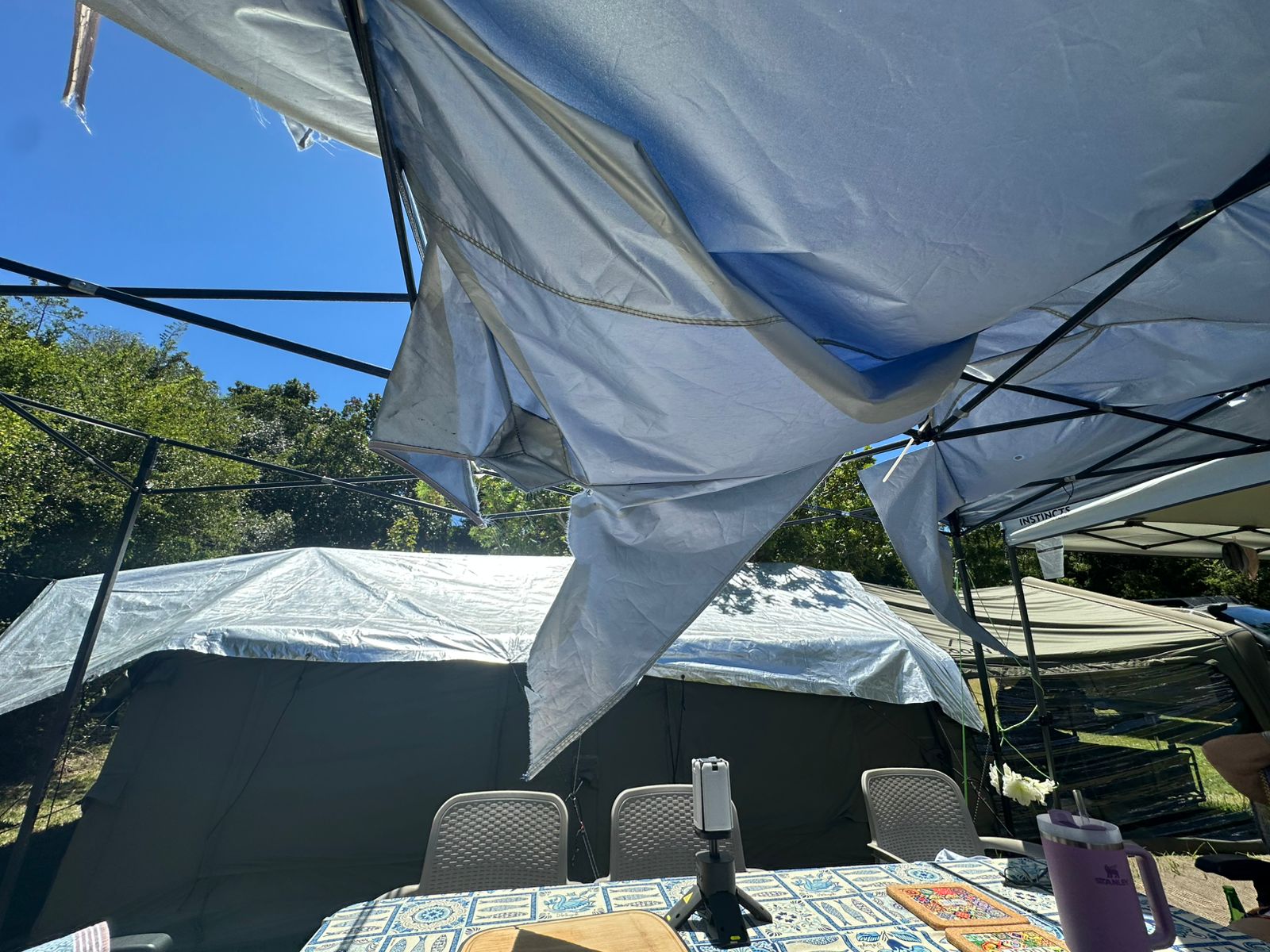 A neighbouring gazebo shredded by a storm in Knysna, while Neil's army green Coody Familia stands intact in the background